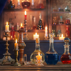 Obraz na płótnie Canvas magic potions in bottles on wooden background