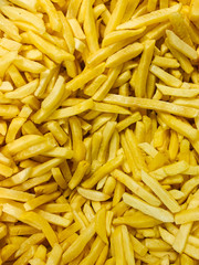lots of potatoes for cooking fries the background