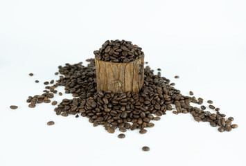 Coffee beans lying on small stump and around