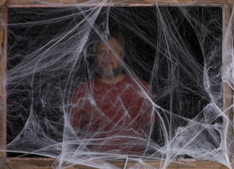 Naklejka premium man in a white spider web on a black background