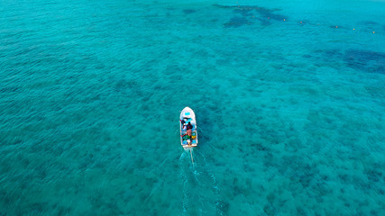 View from above taken from drone, Aerial view of boat sailing on turquoise sea in summer