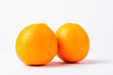 Portrait Of Two Oranges Against White Background