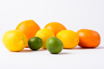 Portrait Of Assorted Citrus Fruits Against White Background