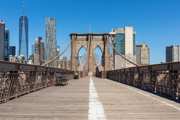 View of lower Manhattan from the empty pedestrian walkway on the Brooklyn bridge in New York City.