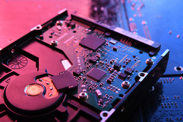 Computer Hard disk drives HDD , SSD on circuit board ,motherboard background. Close-up. With...