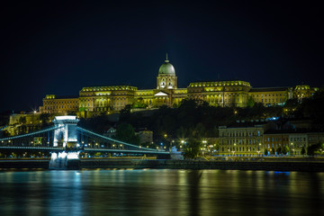 Fototapeta na wymiar Buda Castle sits on a hill above the Danube River and The Chain Bridge in the capitol city of Budapest, Hungary