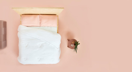 Overhead view of bed in pink room