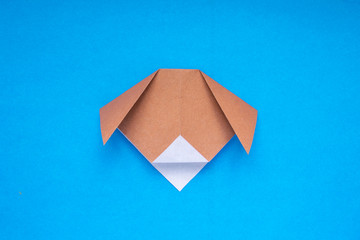 Step by step photo instruction how to make origami paper dog. Simple diy kids children's concept.