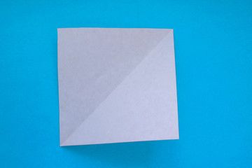 Step by step photo instruction how to make origami paper dog. Simple diy kids children's concept.