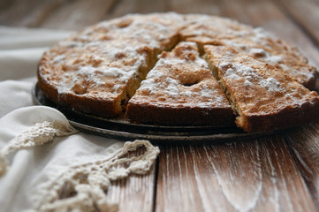 Homemade pie with cherries and apples on a dark rustic wooden board background. Rustic style food