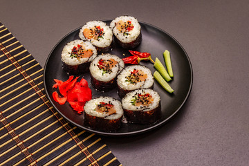 Korean roll Gimbap(kimbob). Steamed white rice (bap) and various other ingredients. Trendy black background