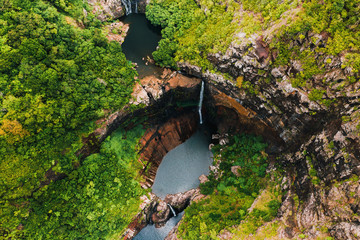 Fototapeta na wymiar Aerial view from above of the Tamarin waterfall seven cascades in the tropical jungles of the island of Mauritius
