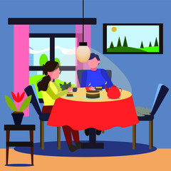 a guy with a girl drinking tea at the table sitting at home. A cozy pastime. Cat sleeping on a chair