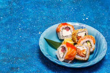 Assorted sushi set. Japanese or Korean roll with different fresh ingredients. Nautical background