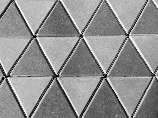 Grey concrete floor, triangle pattern background.