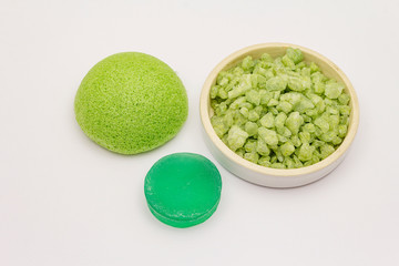 Sea salt, green tea soap and sponge isolated on white background