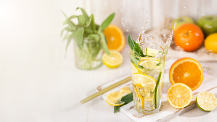 The glass of fresh lemonade with drops of a liquid splash