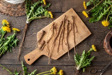 Fotobehang Fresh dandelion roots on a wooden cutting board, top view © Madeleine Steinbach