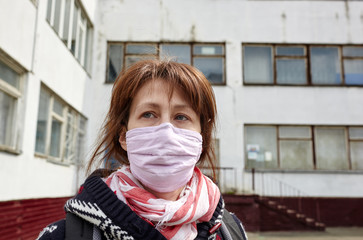 Woman wearing hygienic mask to prevent the Coronavirus. People in masks The outbreak of Novel...