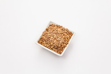 Brown flax seeds isolated on white background