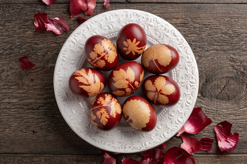 Easter eggs dyed with onion peels on a white plate