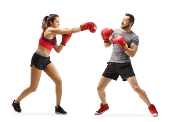 Young man and woman train boxing