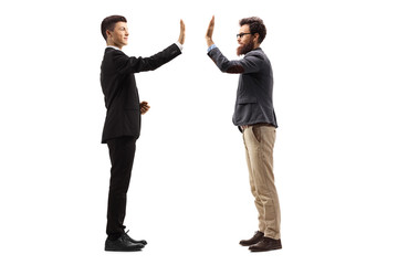 Young guy in a suit gesturing high-five with a bearded man