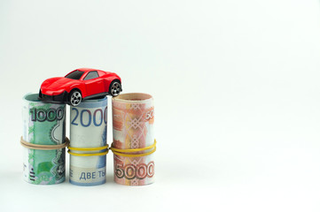 car and money on a white background, the concept of buying a car