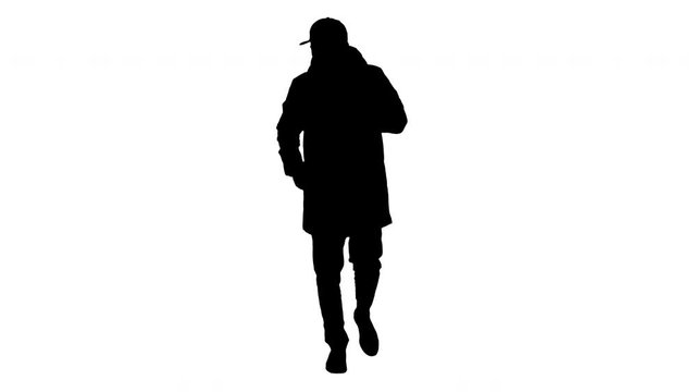 Silhouette Man in winter outfit walking and coughing.