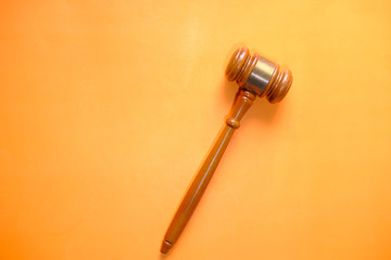 top view of gavel on orange background 