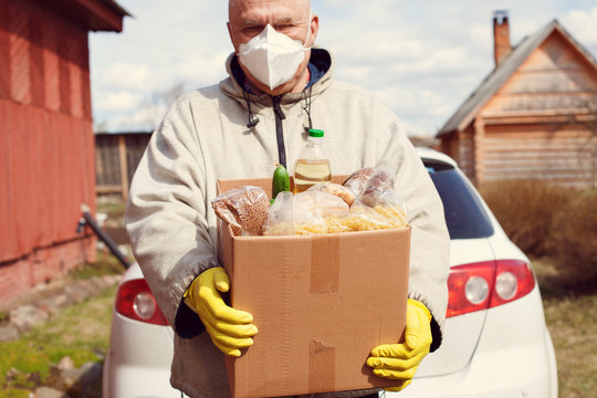 Elderly Male Volunteer Delivers Food To   Village