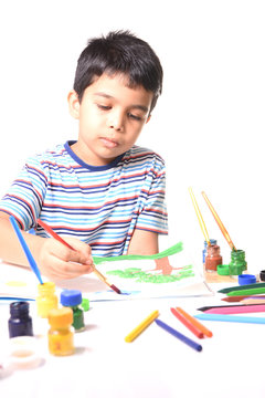 Little Indian kid drawing and painting