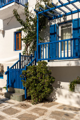 Fototapeta na wymiar Mykonos island street view with white and blue houses in Cyclades, Greece