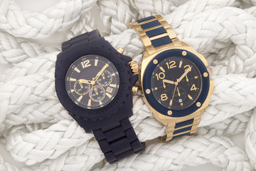 Blue and gold watches on white nautical rope