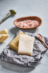 Natural ingredients and accessories for diy cosmetics and home spa treatment on turquoise background, top view.