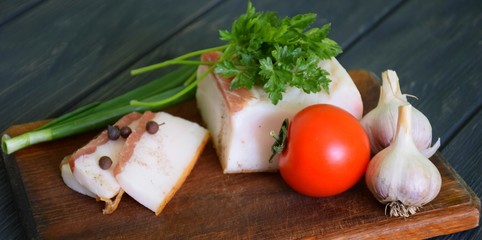 Salty pork lard, sprinkled with ground black pepper and vegetables