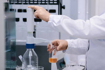 Scientist holding a test tubes, Laboratory research. Scientist with test tube making research in clinical laboratory.