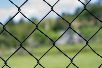 iron chain link fence against sky