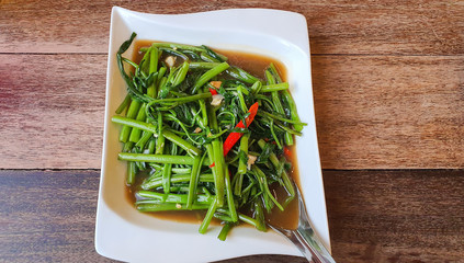 Stir fried morning glory or Water Spinach with chili, soy sauce and garlic. thai food call phad puk boong fri dang.
