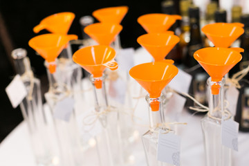 Empty bottle set with funnels for bottling and blending spirits.