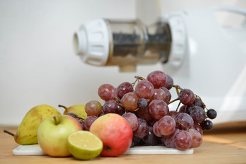 Vitamin C in fruits and vegetables choice just before preparing  Juice with extractor  in white kitchen