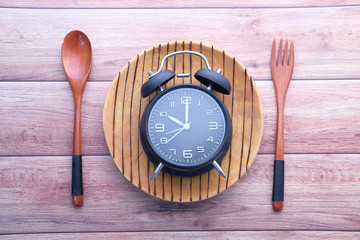 Alarm clock and plate with cutlery, Top view