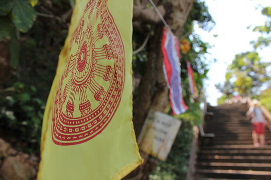 Samsara flag at the stairs to a buddhist temple