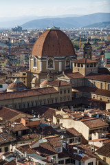 The dome of the Cappella dei Principi dominates the San Lorenzo architectural complex (Medici Chapels). Aerial view from Giotto's Campanile. Florence, Tuscany, Italy.