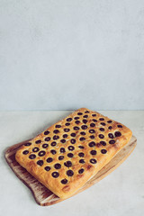 Home made focaccia with black olives - whole