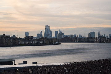 Fototapeta premium London skyline with river at sunset seen from Isle of Dogs
