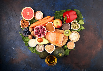 Obraz na płótnie Canvas Healthy food clean eating selection: fish, fruit, vegetable, cereal, leaf vegetable on rustic background
