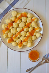 Home made sweet cottage cheese lazy dumplings (vareniki) with apricot jam on top.