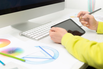 Illustrator designer draws a stylus on a graphic tablet.