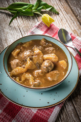 Meatballs in gravy with cast noodles.